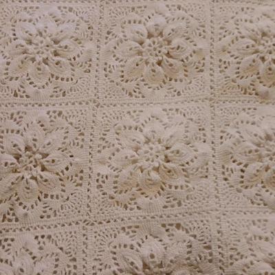 Hand knitted bed spread. square floral pattern