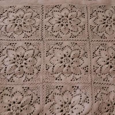 Hand knitted bed spread. square floral pattern