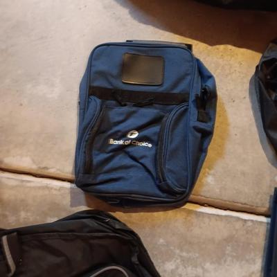 Several black bags - Duffles backpacks - suit covers