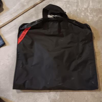 Several black bags - Duffles backpacks - suit covers