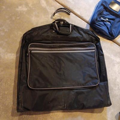 Several black bags - Duffles backpacks - suit covers