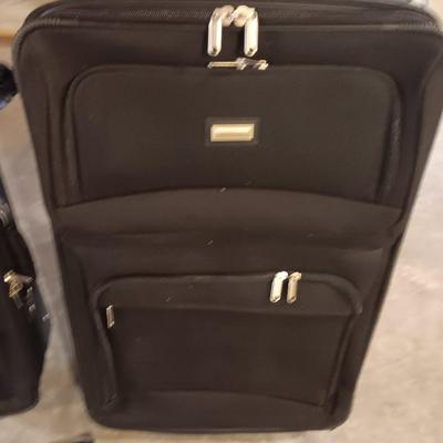 Nice nesting 3-piece PROTOCOL suitcase set with pull along handles - 3 different sizes.