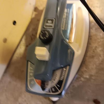 Metal folding ironing board with black& decker clothes iron and clothes pin bag
