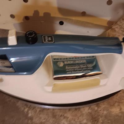 Metal folding ironing board with black& decker clothes iron and clothes pin bag
