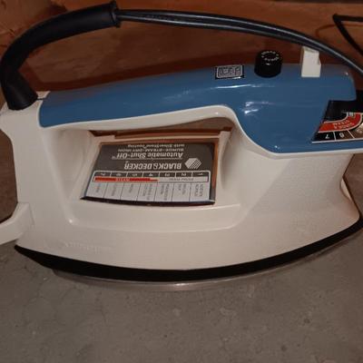 Metal folding ironing board with black& decker clothes iron and clothes pin bag