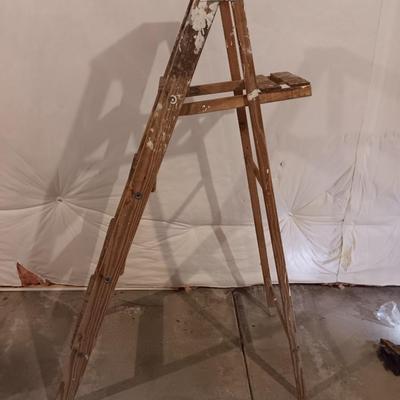 5' wooden ladder with an orange extension cord on a reel