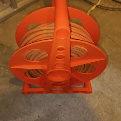 5' wooden ladder with an orange extension cord on a reel