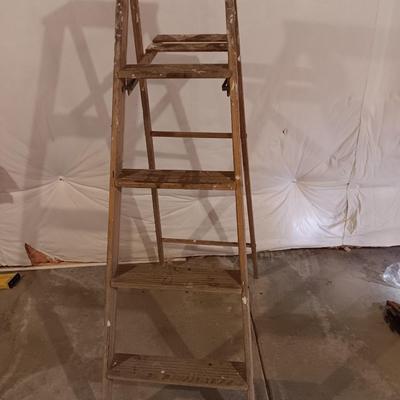 5' wooden ladder with an orange extension cord on a reel