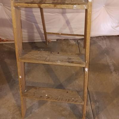 5' wooden ladder with an orange extension cord on a reel