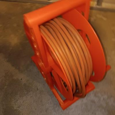 5' wooden ladder with an orange extension cord on a reel