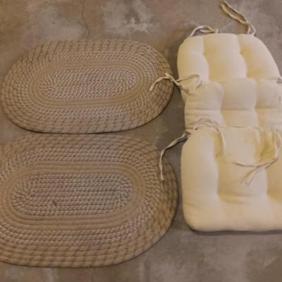 Two woven throw rugs and three white seat / chair cushions