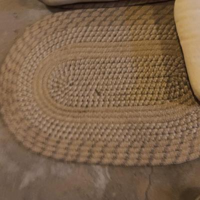 Two woven throw rugs and three white seat / chair cushions