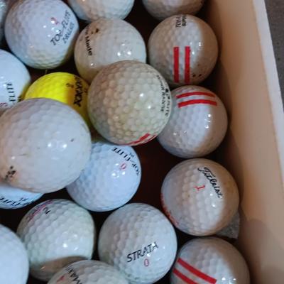 Box with a variety of golf balls