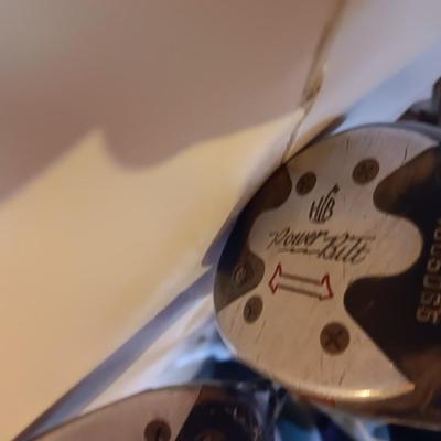Golf bags with golf clubs and accessories.