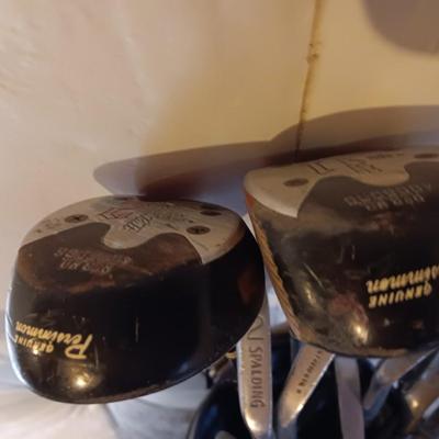 Golf bags with golf clubs and accessories.