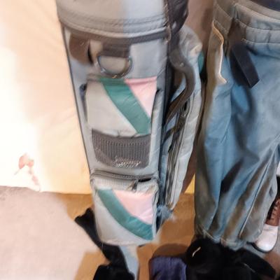 Golf bags with golf clubs and accessories.