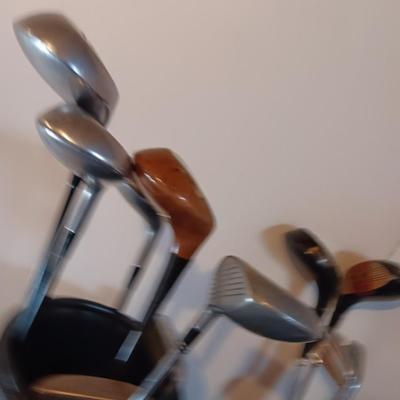 Golf bags with golf clubs and accessories.