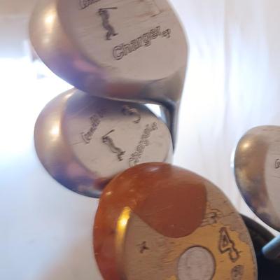 Golf bags with golf clubs and accessories.