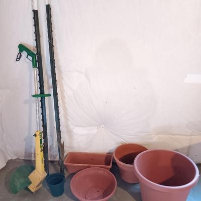 Plastic flowerpots - two T posts and an electric weed eater
