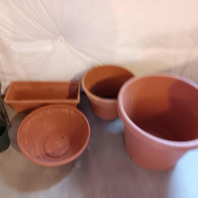 Plastic flowerpots - two T posts and an electric weed eater