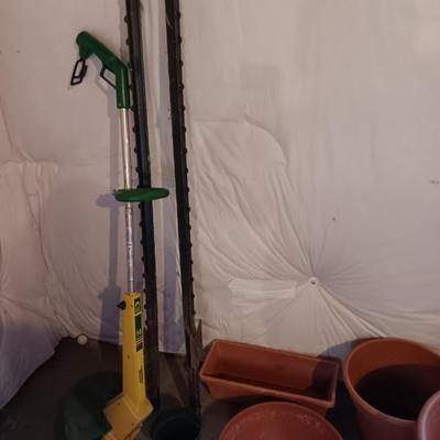 Plastic flowerpots - two T posts and an electric weed eater