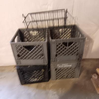 Four plastic milk crates and a wire basket