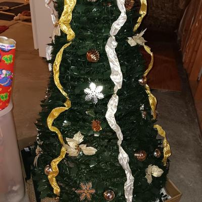 Neat collapsing Instant Christmas tree - decorated and light up with wrapping paper in storage tote