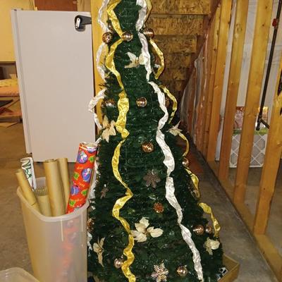 Neat collapsing Instant Christmas tree - decorated and light up with wrapping paper in storage tote