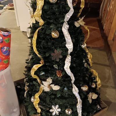 Neat collapsing Instant Christmas tree - decorated and light up with wrapping paper in storage tote