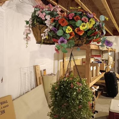 Three metal hanging baskets with faux flowers