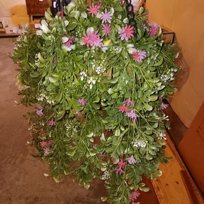 Three metal hanging baskets with faux flowers