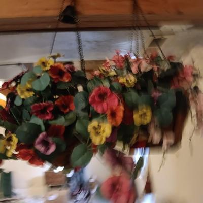 Three metal hanging baskets with faux flowers