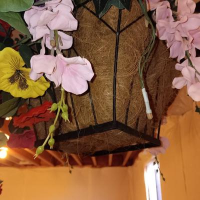 Three metal hanging baskets with faux flowers