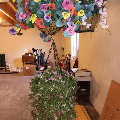Three metal hanging baskets with faux flowers