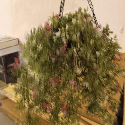 Three metal hanging baskets with faux flowers