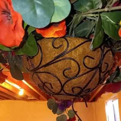 Three metal hanging baskets with faux flowers
