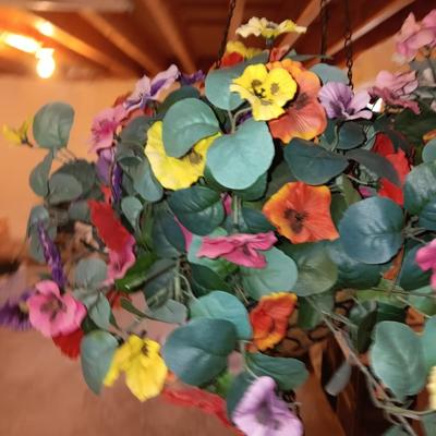 Three metal hanging baskets with faux flowers