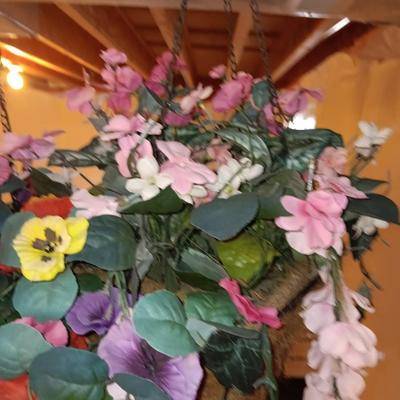 Three metal hanging baskets with faux flowers