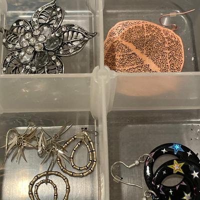 Plastic container of earrings and more