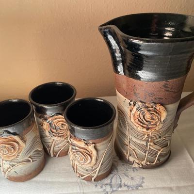 Floral ceramic pitcher and 3 cups