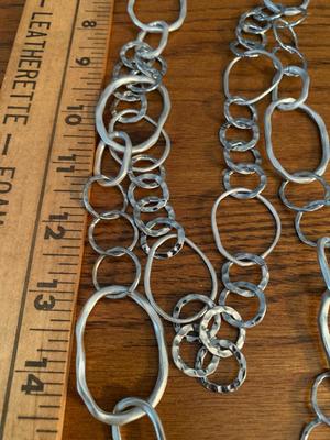 Group of silver color circle necklaces, Chicos