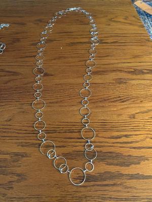 Group of silver color circle necklaces, Chicos