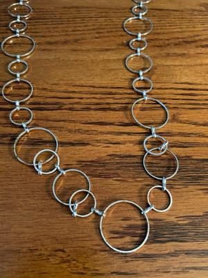 Group of silver color circle necklaces, Chicos