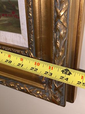 Gold framed oil painting with accent light