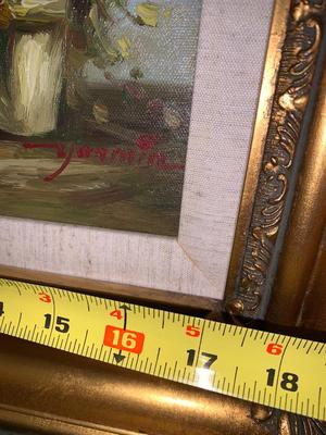 Gold framed oil painting with accent light