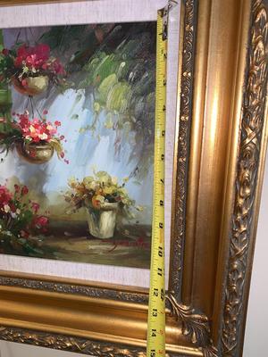 Gold framed oil painting with accent light