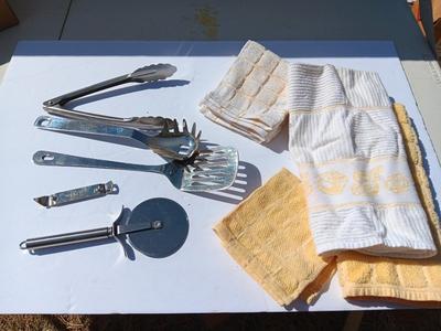 Stainless metal kitchen utensils with dish towels