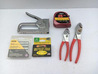 Variety of hand Tools - Stapler with staples - pliers - and 25-foot tape measure