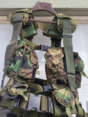 Military issued tactical load bearing vest with accessories.