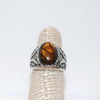 Size: 6 Â½ Dome Oval Tiger Eye Stone on Groove Designed Silver Tone Band (7.2g)